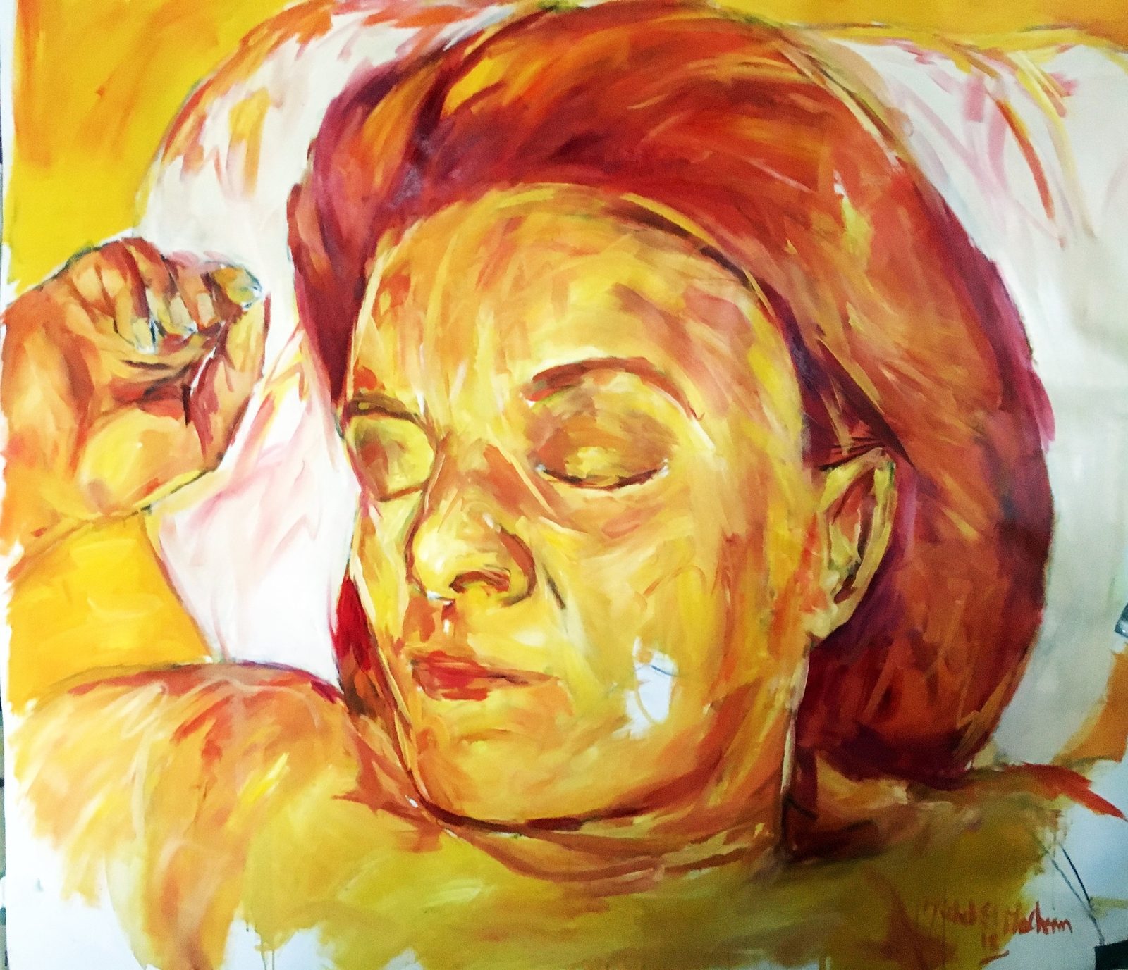 Leila, asleep with a fist beside her face, in yellow and orange